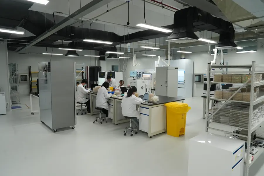 Scientists working at benches in the lab