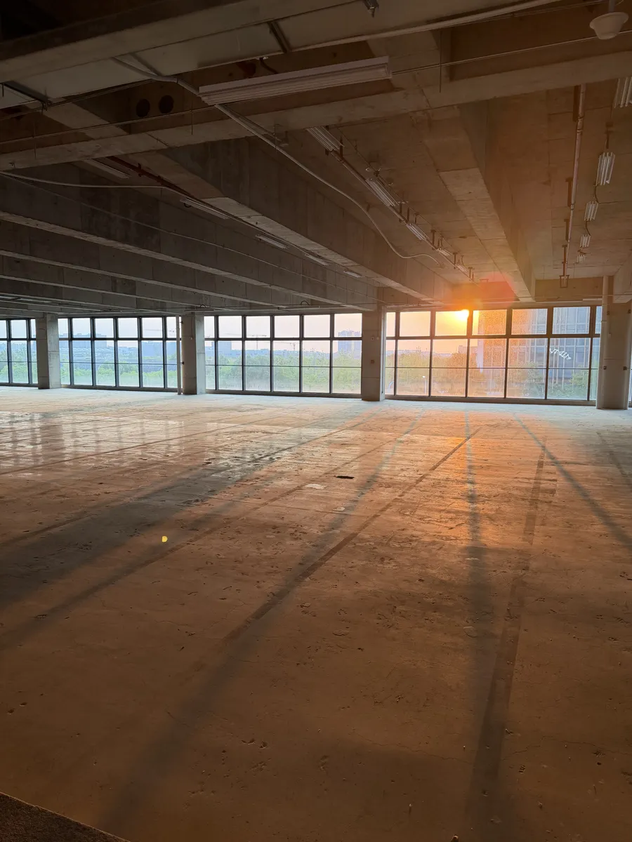 Sunset through the windows of the empty floor before construction